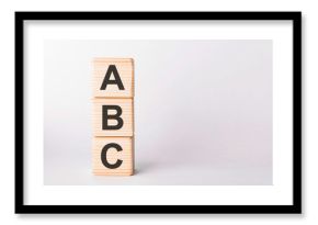 ABC letters of wooden blocks in pillar form on white background, copy space