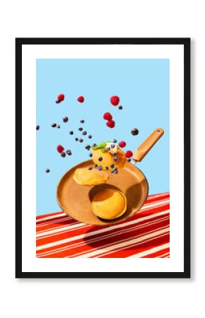 Food pop art photography. Close up. Flying frying pan with hot, sweet, delicious pancakes with berries. Vintage, retro 80s, 70s style, interior. Complementary colors.