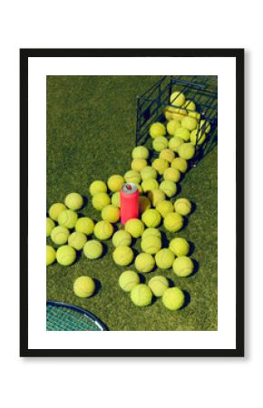 Pink mockup can surrounded by scattered tennis balls on grass court. Concept of lifestyle branding, sport leisure advertising, beverage campaigns, and editorial party visuals.