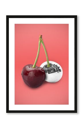 Disco ball fruit. One of cherries with mirror facets on coral color background