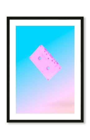 Flying compact retro cassette on pink and blue background.  Minimal vaporwave.concept.