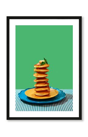 Food pop art photography. Delicious sweet pancakes with maple syrup and batter on plates over green background. Vintage, retro 80s, 70s style. Complementary colors.