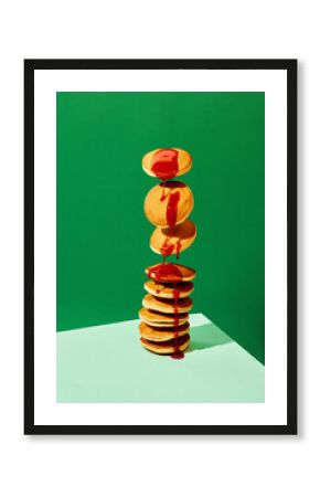 Food pop art photography. Close up. Flying sweet pancakes with delicious jam over green background. Vintage, retro 80s, 70s style, interior. Complementary colors.