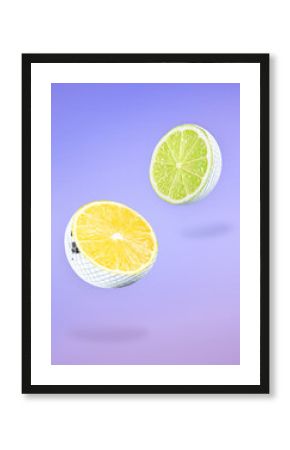 Disco balls with citrus fruits inside. Halves in air on violet gradient background