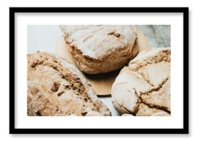 Assorted homemade bread on white clean wood background.Fresh tasty bread.Bakery - rustic crusty loaves of bread and buns.Homemade natural breads. Different kinds of fresh bread as background