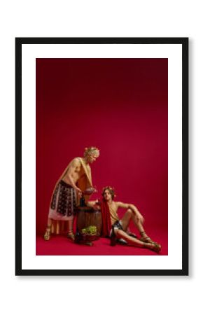 Two men in togas with barrel and wine jug in festive scene. Concept of lifestyle magazines, restaurant branding, social content, and creative advertising campaigns.