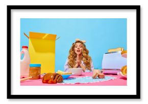 Food pop art photography. Image of excited woman putting hands together with hunger eyes on pink tablecloth over light blue background