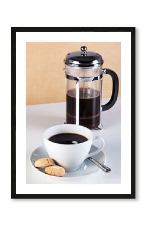 Cup of coffee with cafetiere and amaretti biscuits
