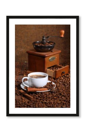 Still-life from coffee in a white cup, cinnamon, an anise and a