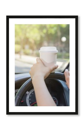 Women holding white coffee cup and drinking while driving, morni
