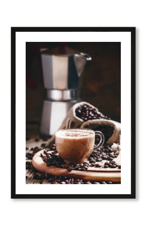 Coffee with milk in a glass cup, coffee beans in bags of canvas,