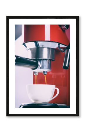 red espresso coffee machine is making a coffee