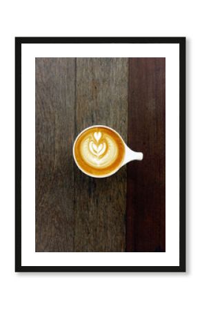 cup of latte art coffee on wooden background