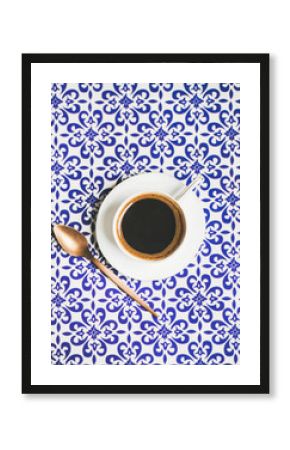 Cup of black Turkish or Eastern style coffee over oriental Moroccan patterned background, top view