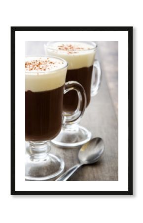 Irish coffee in glass on wooden table  