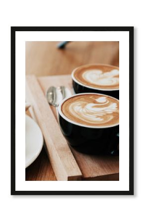 Breakfast with coffee and croissants in a wooden tray on table