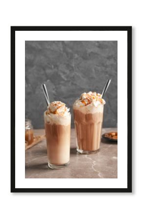 Glasses with delicious caramel frappe on table