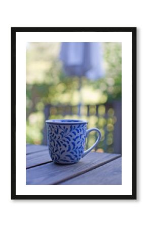 Mug in blue pattern on wooden table