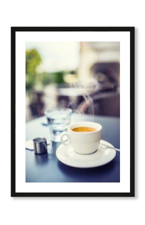 Cup of coffee on table in restaurant terrace