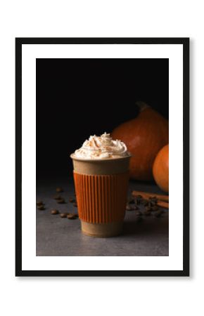 Paper cup with tasty pumpkin spice latte on gray table