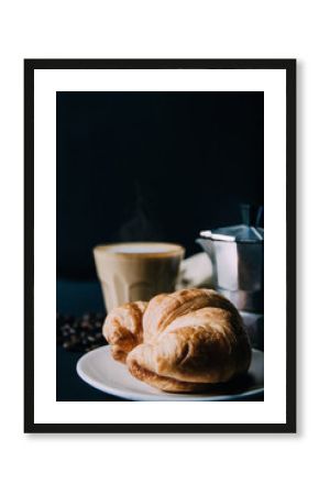 Croissant ,Latte art ,and moka pot with Roasted coffee on black background in the morning and instagram style filter photo vintage tone