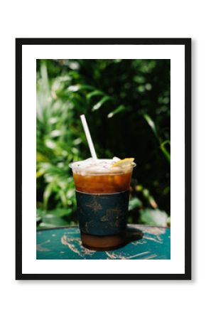 Iced cold brew coffee with lemon on a table