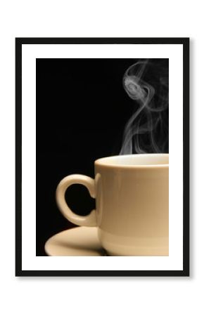 Cup of coffee close-up with steam over black background