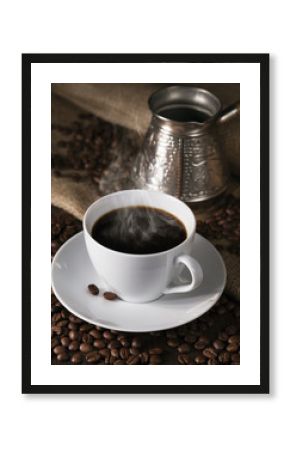 Fuming cup of coffee, coffee maker and coffee grains round them