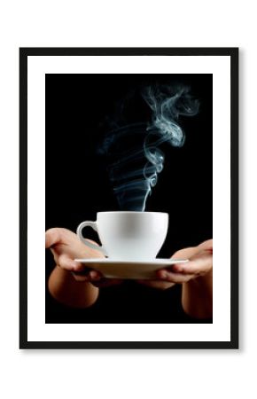 Cup of coffee in the women's hand on black background
