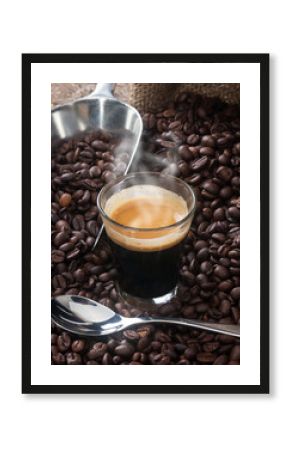 Espresso coffee in glass cup with coffee beans.