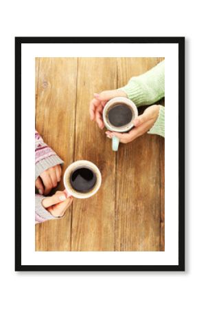 Female hands holding cups of coffee