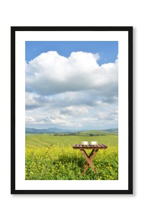 Coffee and cantuccini on the wooden table against Tuscan landsca