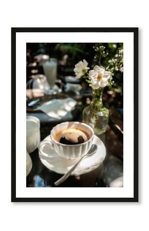 A cup of Black Coffee placed on glass table