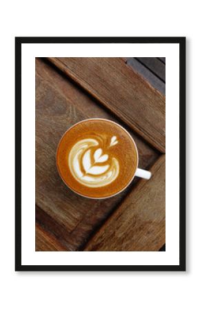 cup of latte art coffee on wooden background