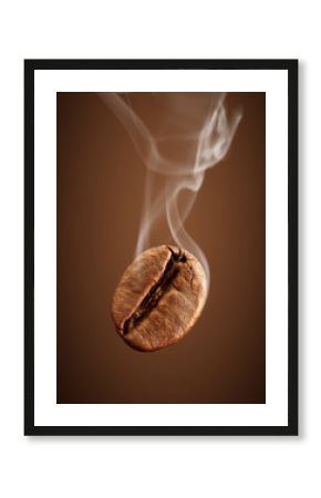 Closeup falling coffee bean with smoke on brown background