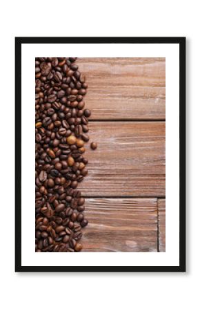 Roasted coffee beans on a brown wooden table