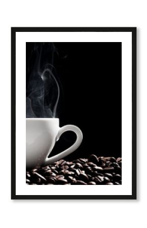 Steaming coffee cup put on coffee beans isolated on black background.