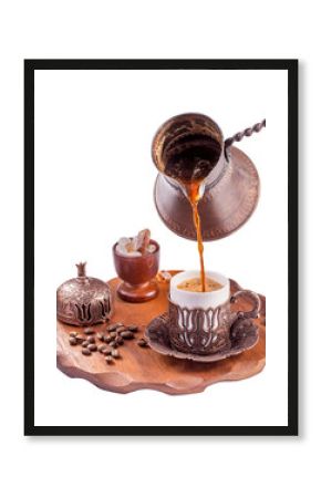 Traditional turkish coffee pouring isolated on white. Embossed metal cup and cezve.