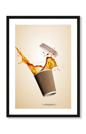 Cup with splashing coffee or tea liquid separated on brown background. Take away hot drink