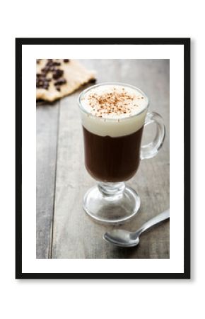 Irish coffee in glass on wooden table  