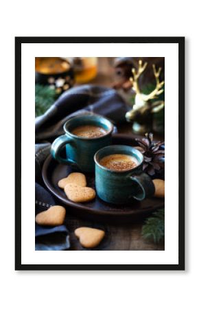 Cozy table setting with two cups of espresso coffee served with heart shaped cookies