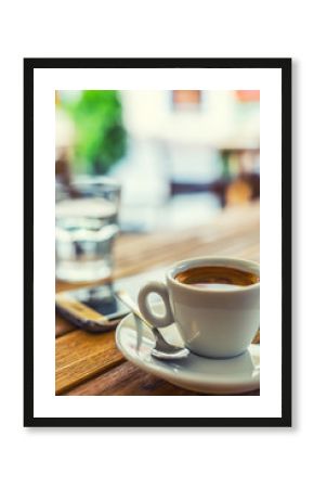 Coffee. Cup of coffee mobile phone on table on restaurant coffee house terrace. Coffee break business