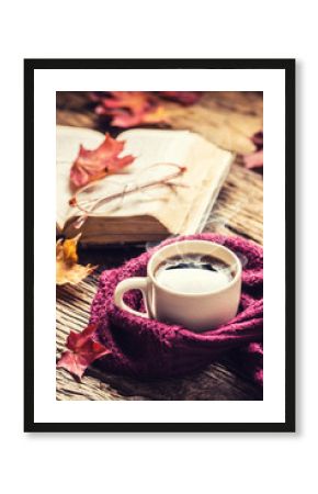 Cup of coffee old  book glasses and autumn leaves.