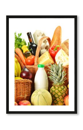 Groceries in wicker basket isolated on white