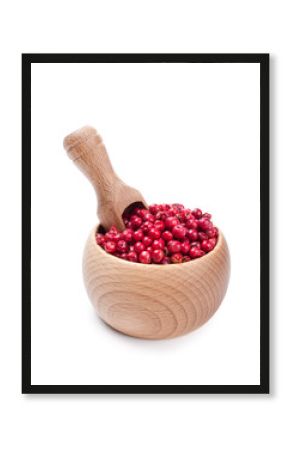 Wooden scoop in bowl full of pink pepper