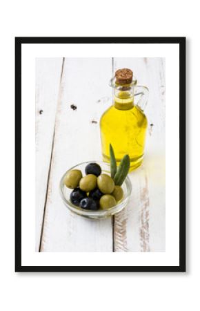Virgin olive oil in a crystal bottle on white wooden table  
