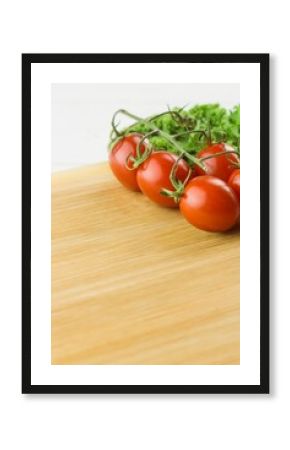 Tomatoes and parsley on chopping board against white background