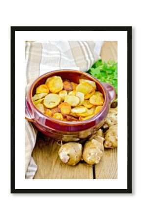 Jerusalem artichokes fried in a pan on the board