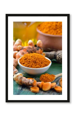 fresh turmeric roots on wooden table