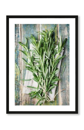 Bunch of rosemary on wooden table, rustic style, fresh organic herbs, top view
